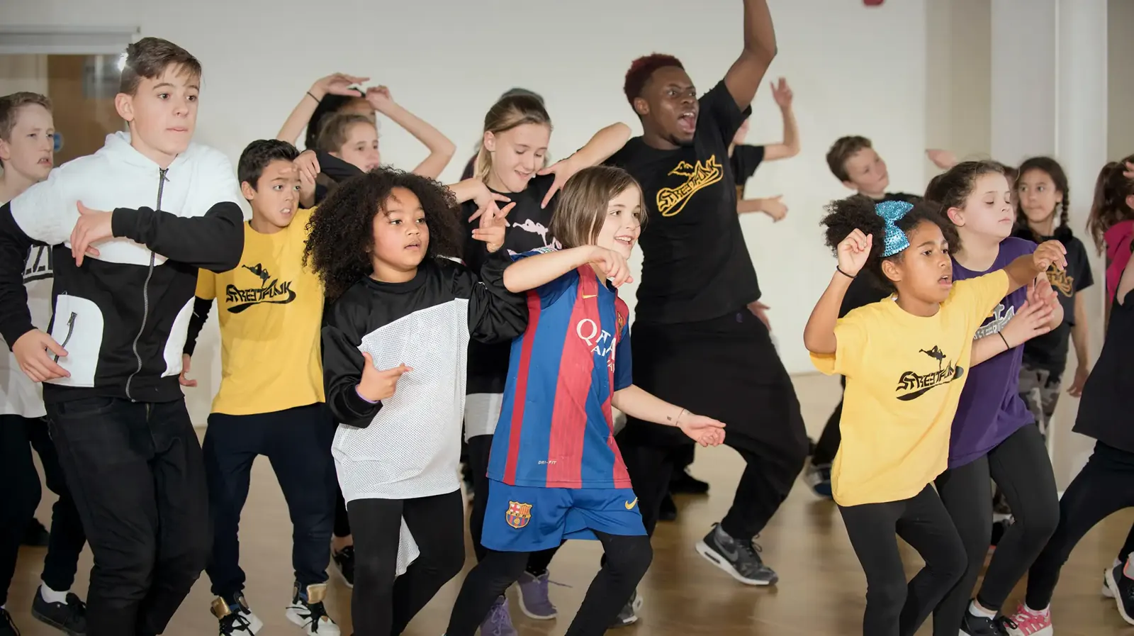 Kids dancing with energy at a Streetfunk class