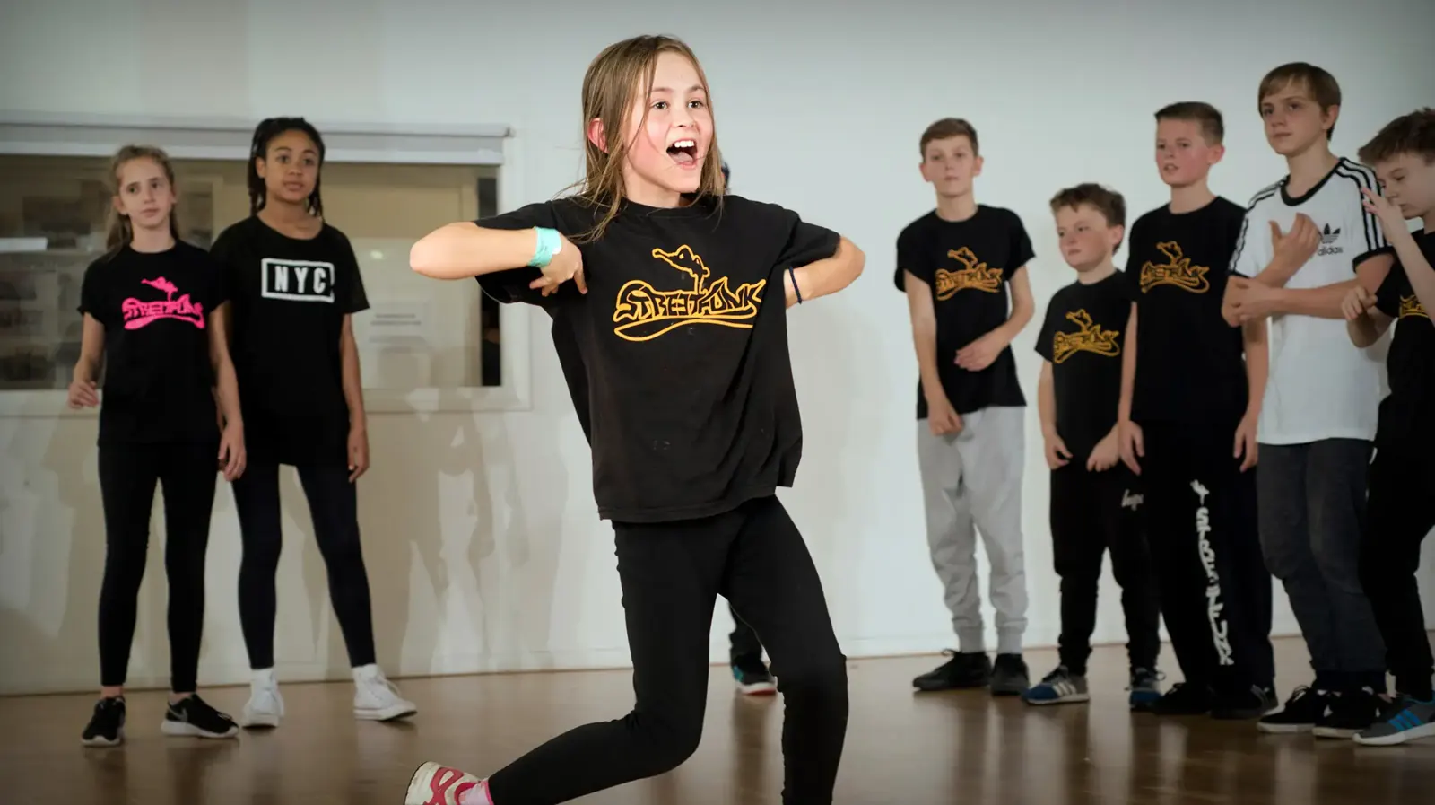 Teen dancer mid-move in a Streetfunk class